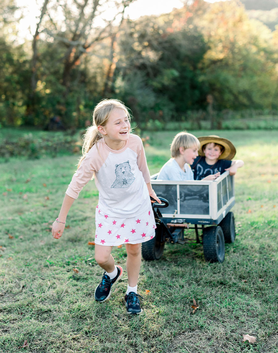 Kids pulling each other in a wagon.